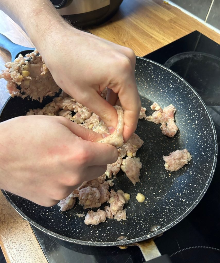 Squeezing the sausage meat into the pan